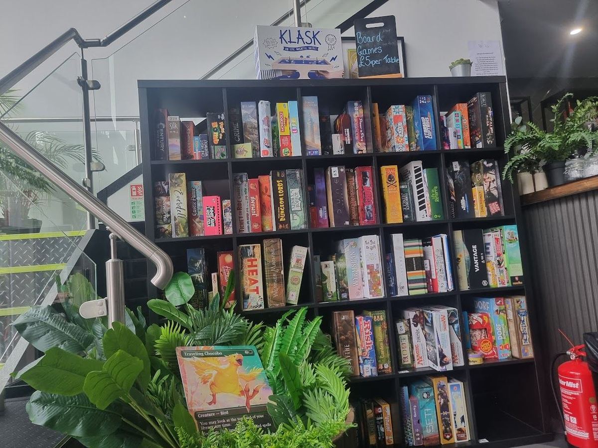 Shelves of board games by the stairs